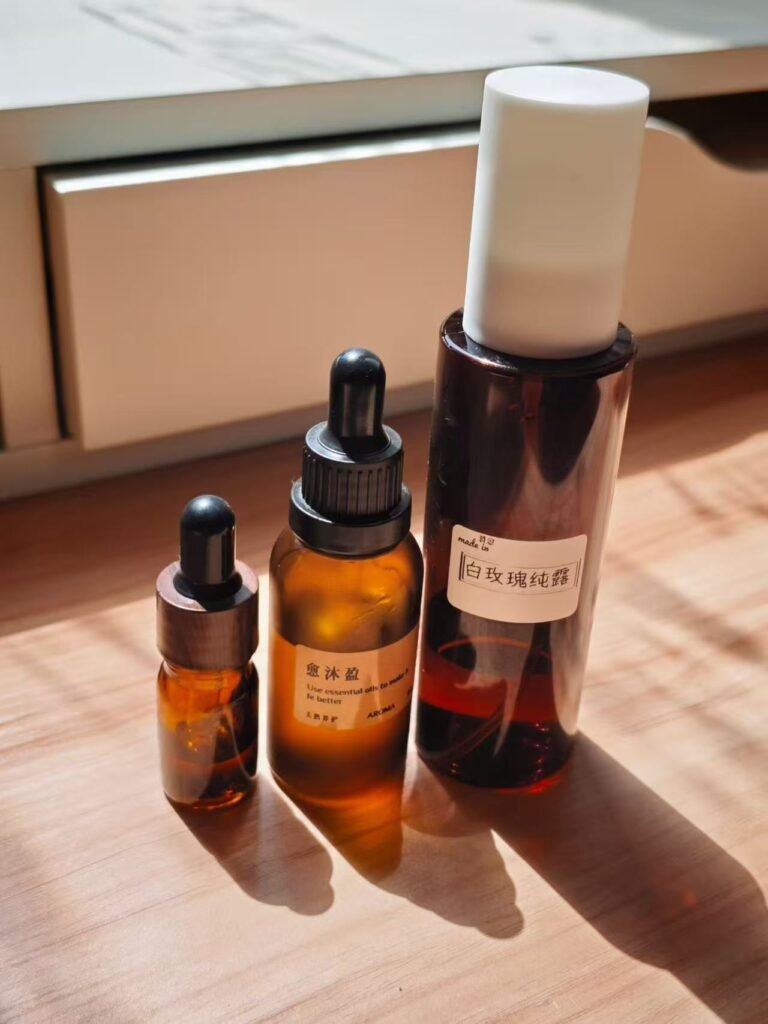A botanical sleep ritual set featuring amber essential oil dropper bottles in natural sunlight to quiet a racing mind before bed.