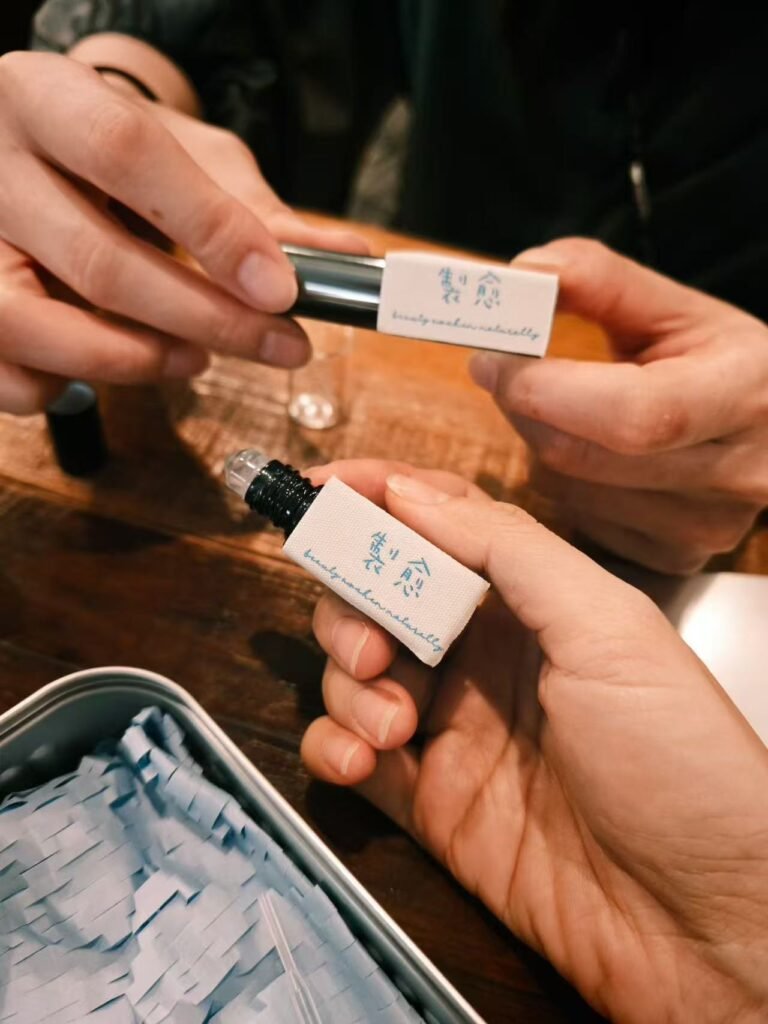 Two hands holding Vessy Oils artisan synergy blends, featuring pure botanical ingredients recommended for safe use inside the nasal passages.