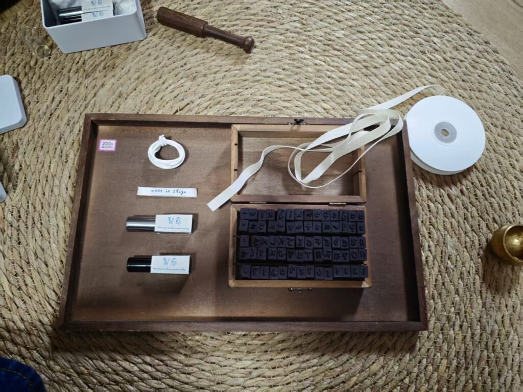 Two essential oil roller bottles arranged on a wooden tray